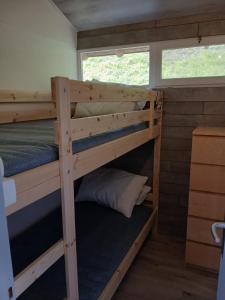 a bedroom with two bunk beds in a tiny house at La Bella Garda in Tignale