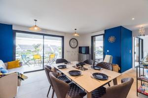 a dining room with a large table and chairs at Les terrasses de Ploumanac'h 150m de la plage in Perros-Guirec +11 photos