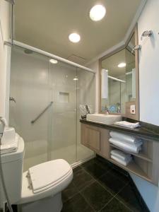 La salle de bains est pourvue d'une douche, de toilettes et d'un lavabo. dans l'établissement Radisson Oscar Freire, à São Paulo