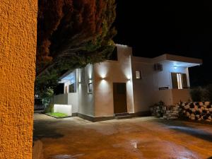 a house is lit up at night at VILA GOLDEN SAND in Ksamil