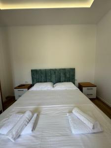 a large white bed with two white towels on it at VILA GOLDEN SAND in Ksamil +31 photos