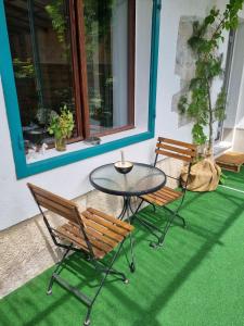 two chairs and a table on a patio at Comfortable Apartment & Studio in Village Centre in Komen