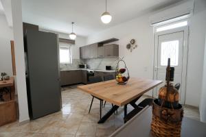 a kitchen and dining room with a wooden table at Anna's Apartments in Kremasti