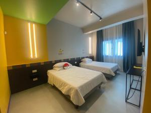 a hospital room with two beds and a television at The Match Hotel in Cervia
