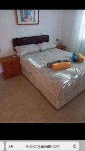 a bedroom with a large bed and a wooden dresser at Spanish Villa in Torre del Rame