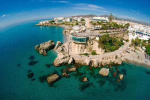an aerial view of a beach with rocks in the water at Apartamento Diputación 25 in Nerja