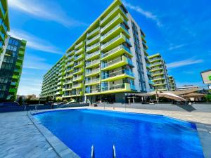 a large apartment building with a large swimming pool at Alezzi Beach Resort - Sea View Suite in Mamaia Nord