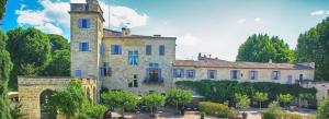 a large stone building with a tower on top at APPART'ICI 2 - Spacieux studio in Lunel-Viel