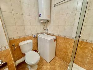 a small bathroom with a toilet and a shower at Arkite - Private apartment - BSR in Sunny Beach +10 photos