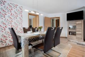 a dining room with a table and chairs at Bungalow Bei Rügen in Sundhagen