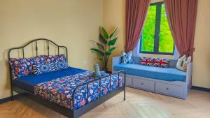 a bedroom with two beds and a window at Mawarvilla jb in Johor Bahru