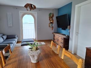 奥斯塔Aosta Holiday Apartments - Edelweiss的客厅里有一张桌子和一张沙发