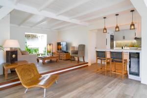 a living room with a table and chairs and a kitchen at Paradisiacal Villa in Saint Barthélemy with Private Pool in Saint Barthelemy