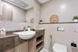 a bathroom with a sink and a toilet at Silkhaus Luxury 1BDR Near NYU Abu Dhabi in Abu Dhabi +9 photos