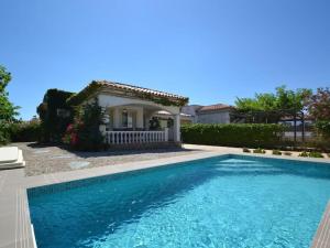 a swimming pool in front of a house at Viamar in Riumar