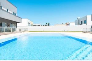 a swimming pool in front of a building at Oporto city and Beach apartment in Lavra