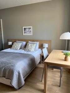 a bedroom with a bed and a desk and a table at Ruka Chalet Front Base in Ruka