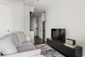 a living room with a couch and a flat screen tv at West Village 2br w wd nr shopping NYC-1274 in New York
