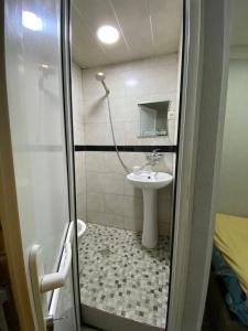 a small bathroom with a sink and a shower at комната в старом тбилиси in Tbilisi City