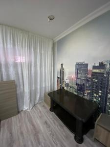 a room with a ping pong table in front of a window at комната в старом тбилиси in Tbilisi City