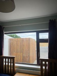 a window with a view of a wooden fence at Easter Snow Galway City in Galway