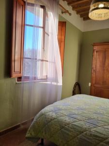 Postel nebo postele na pokoji v ubytování Casa Fleurdelys Toscana