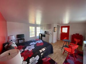 a bedroom with a bed and a living room at Maison Gauthier in Tadoussac