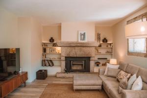 a living room with a couch and a fireplace at Just Like Home - Casa de São Sebastião em Cerveira in Linhares