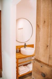 a bathroom with a sink and a mirror at Just Like Home - Casa de São Sebastião em Cerveira in Linhares