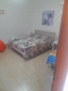 a bed sitting in the corner of a room at Bed and fly Aeroporto Fontanarossa reception h24 in Catania