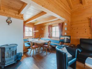 a living room with a table and a stove at Chalet Königsleiten 1 by Interhome in Königsleiten +26 photos