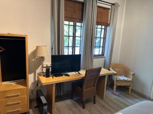 a desk with a computer on it in a room at Melville Turret Guesthouse in Johannesburg