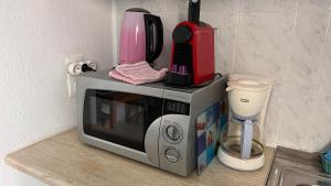 a microwave sitting on a counter next to a blender at Garden House in Khóra Sfakíon