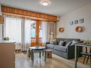 a living room with a couch and a table at Apartment Eaux-Vives 213 by Interhome in Ovronnaz