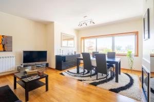 a living room with a table and a dining room at Porto Sea Front Apartment in Lavra