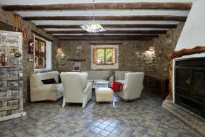 a living room with white chairs and a fireplace at Cortijo el Soto in Beas de Segura +30 photos