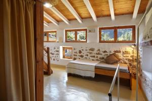 a bedroom with a bed in a room with windows at Cortijo el Soto in Beas de Segura