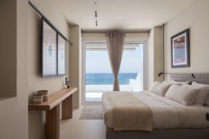 a bedroom with a bed and a large window at Casa Amalia in Aghia Marina