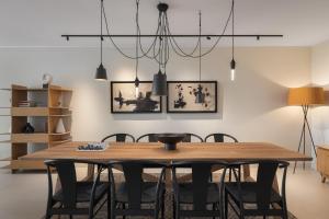 a dining room with a wooden table and chairs at Casa Amalia in Aghia Marina