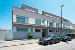 two cars parked in front of a building at Porto Sea Front Apartment in Lavra