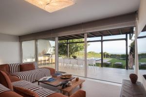 a living room with a couch and a table at Casa Amalia in Aghia Marina +56 photos