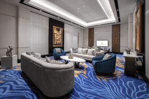 a living room with couches and chairs and a table at InterContinental Bali Resort by IHG in Jimbaran