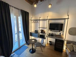 a living room with a large window and a television at Olivuzza 27 in Palermo