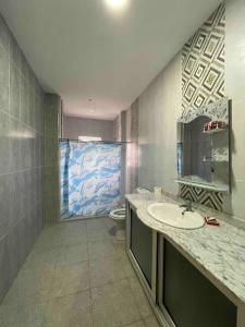 a bathroom with a sink and a toilet at Spacious two room apartment with a super view in Bizerte