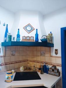a kitchen with a sink and a blue shelf at LUMINIAN Big Modern Villa with outstanding views sea & countryside in Mijas