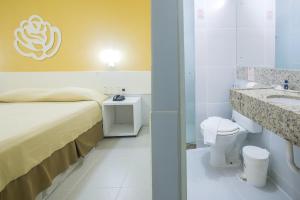 a hotel room with a bed and a bathroom at Hotel Pousada Tamandaré - PB in João Pessoa