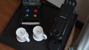 a box with two coffee cups and a remote control at The Westin Istanbul Nisantasi in Istanbul