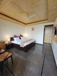 a bedroom with a bed and a wooden ceiling at Oak Nest by Devlok Villas in Mussoorie
