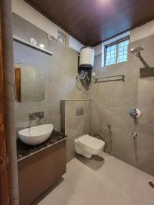 a bathroom with a toilet and a sink at Oak Nest by Devlok Villas in Mussoorie +40 photos