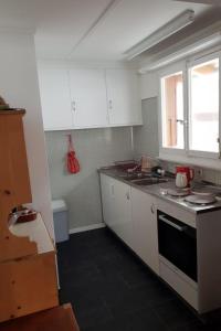 阿德爾博登的住宿－Apartment Bodehus by Interhome，厨房配有白色橱柜、水槽和窗户。